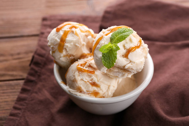 Delicious ice cream with caramel syrup - Fotó, kép