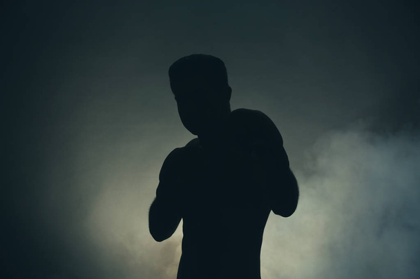 Silhouette of strong male boxer  - Foto, afbeelding