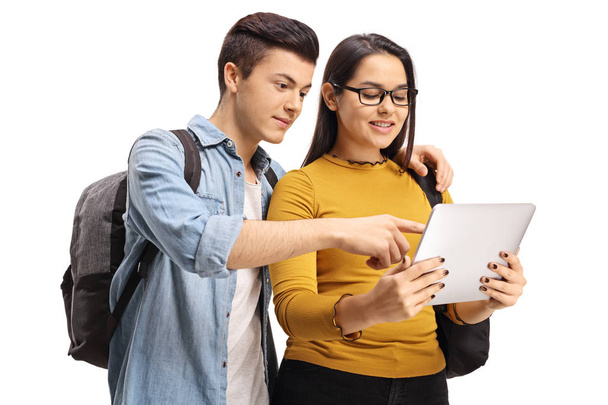 Teenage students looking at a tablet - Zdjęcie, obraz