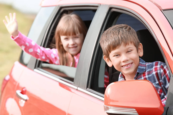 Cute children looking out of car - Foto, Imagen