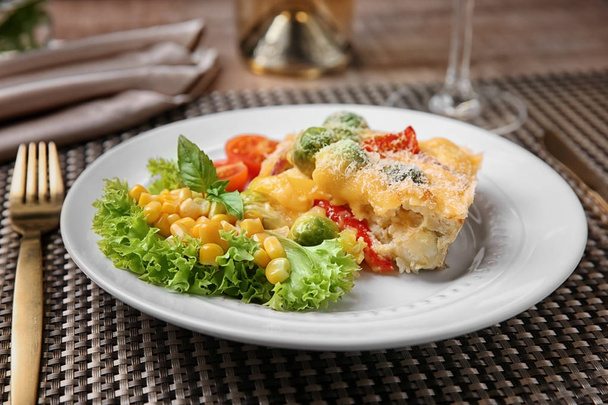 Plate of tasty baked Brussels sprouts with cheese on table - Fotoğraf, Görsel