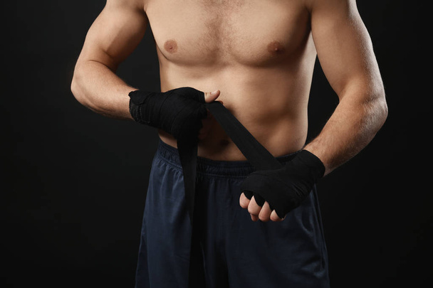 Male boxer applying wrist wraps  - Zdjęcie, obraz