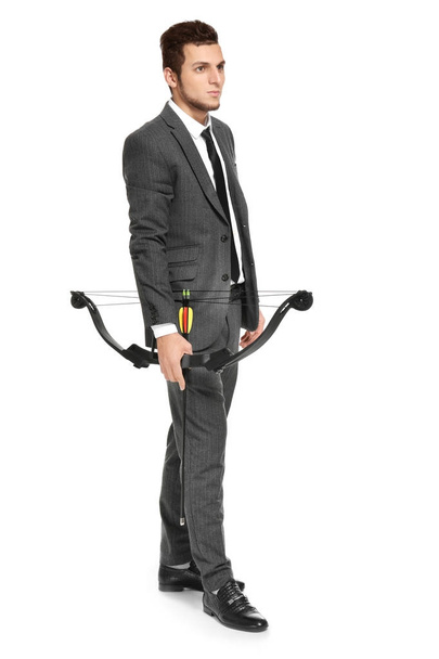 Young businessman with bow and arrow on white background - Valokuva, kuva