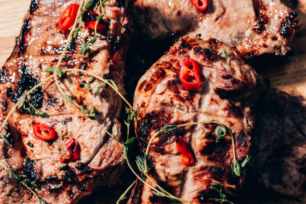 close-up view of delicious juicy grilled meat with spices   - Fotografie, Obrázek