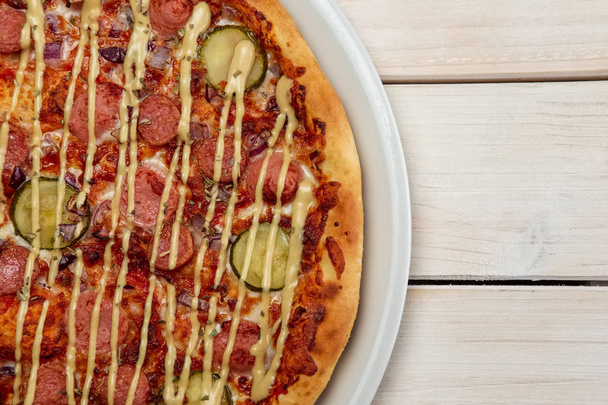 Top view of pizza with sausage and pickled cucumber - Foto, Imagen