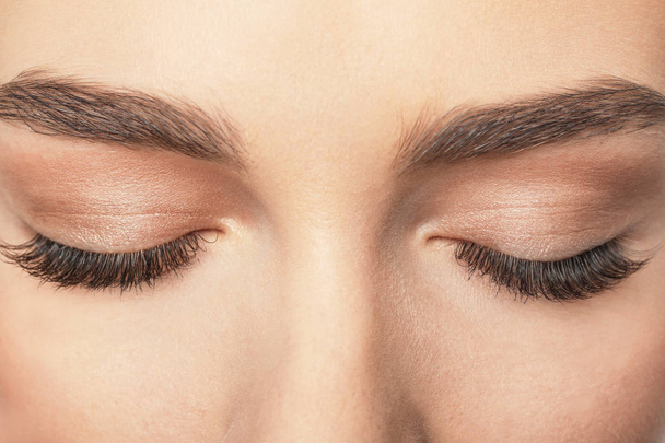 Closed female eyes with long eyelashes, closeup - Foto, imagen