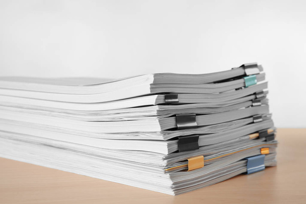 Stack of documents on table against light  background - Foto, afbeelding
