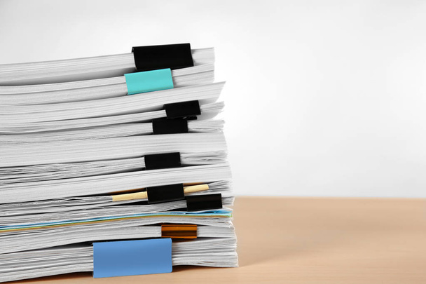 Stack of documents on table against light  background - Foto, immagini