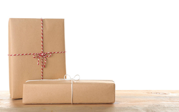Parcel gift boxes on table against white background - Foto, immagini