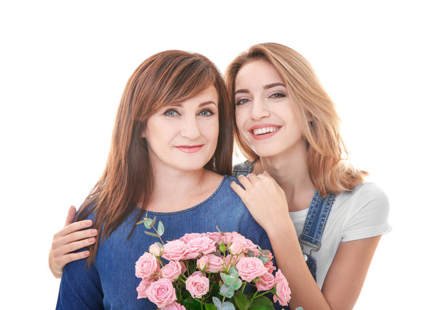Attractive young woman with her mother on white background - 写真・画像