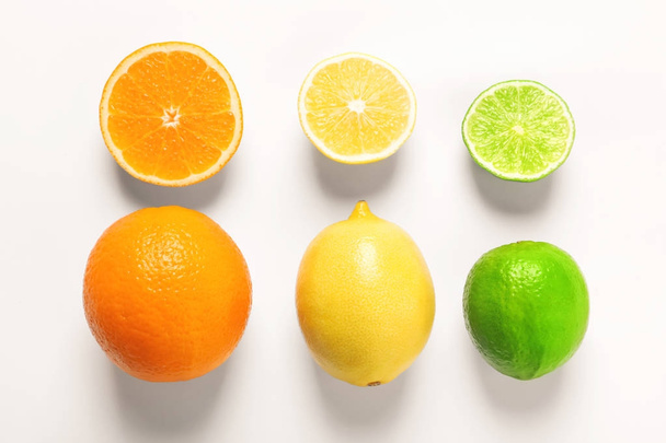 Composition with ripe lemon, orange and lime on white background - Photo, Image