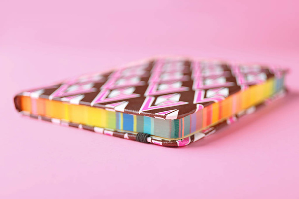 Notebook with rainbow pages on color background, closeup - Foto, imagen