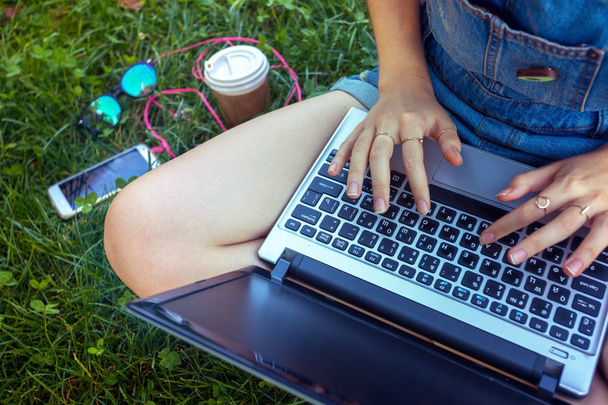 Teen girl sitting with a laptop  - 写真・画像