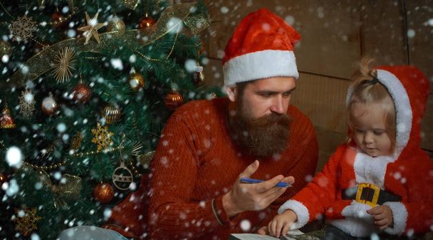 Santa claus kid and bearded man at Christmas tree. - Foto, Bild