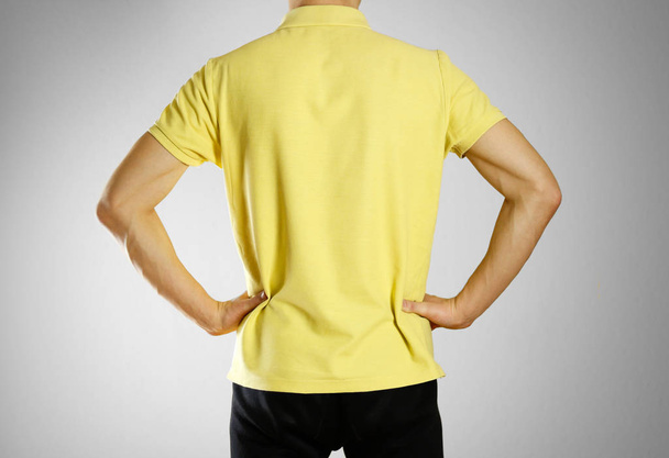 The guy in the yellow blank t-shirt Polo. Prepared for your logo - Valokuva, kuva