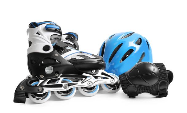 Roller skates and helmet on white background - Foto, imagen