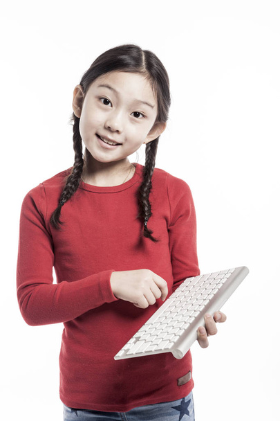 cute asian girl holding a keyboard. - Photo, Image