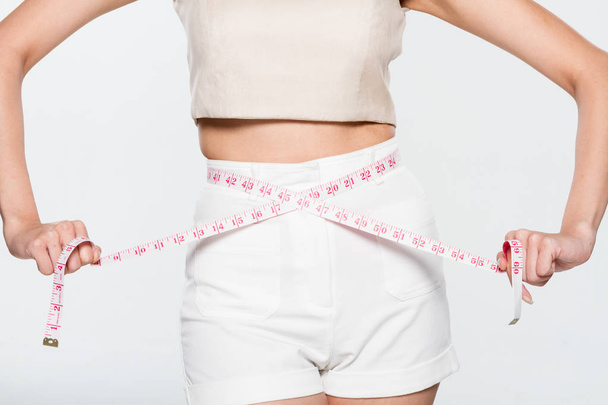 Close Up Woman measuring her waistline with measure line - Photo, Image