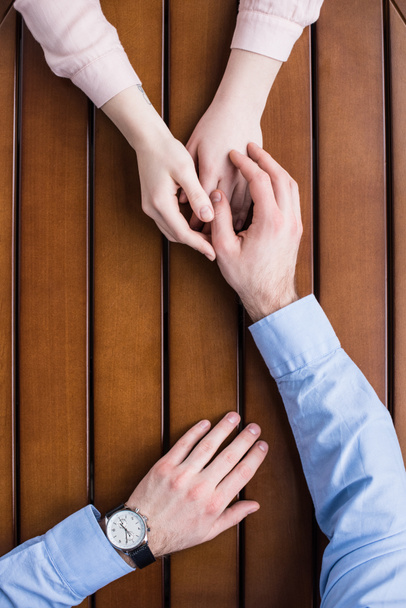 cropped image of man palming hand on girlfriends hands - Фото, изображение