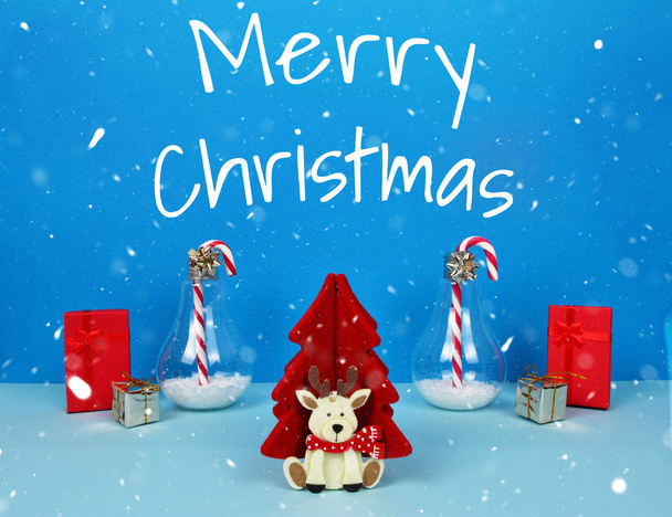 Christmas composition with Santa, decorative christmas tree, gifts and candy canes. - Photo, Image