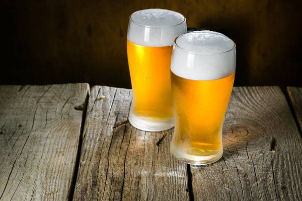 Beer in frosty mugs on rustic background - Foto, immagini