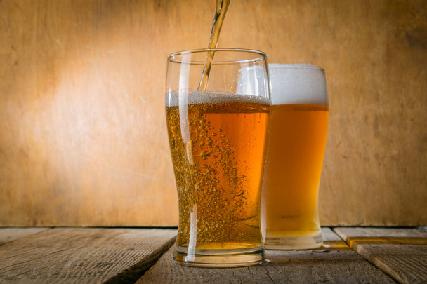 Beer in frosty mugs on rustic background - Foto, immagini
