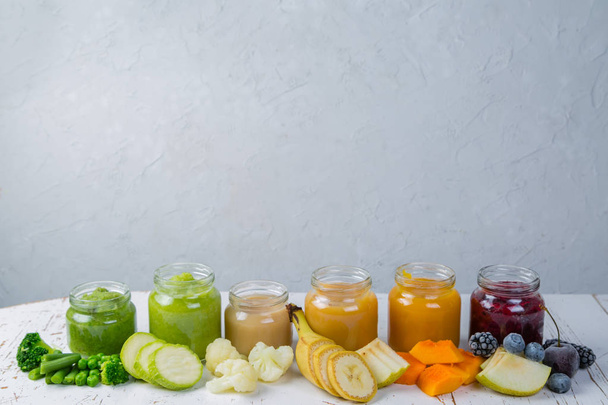 Colorful baby food purees in glass jars - 写真・画像