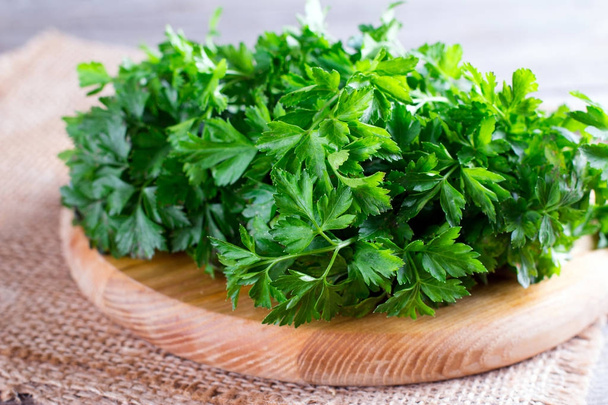 Heap of green fresh raw parsley on old wooden planks - Photo, Image