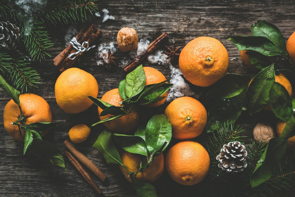 Composition with tangerines, spices, nuts and fir tree - Valokuva, kuva
