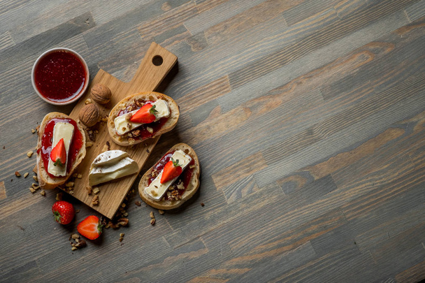top view of delicious sandwiches with jam on wooden cutting board - Фото, зображення