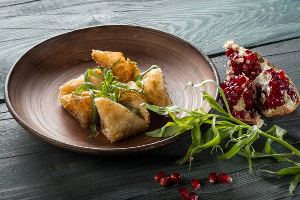 fresh tasty pastry with pomegranate on blue wooden table with copy space - Valokuva, kuva