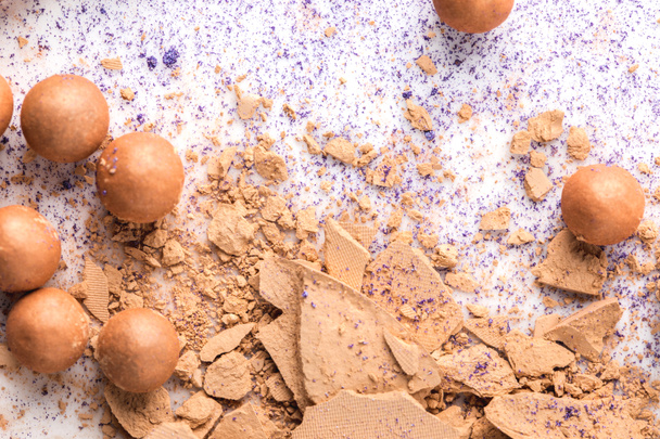 close-up shot of crushed cosmetic powder on white table - Photo, Image