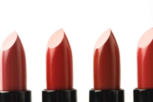 close-up shot of row of lipsticks of various shades isolated on white - Foto, Imagem