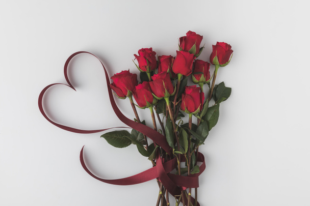 top view of beautiful red roses with ribbon isolated on white, st valentines day concept - Photo, Image