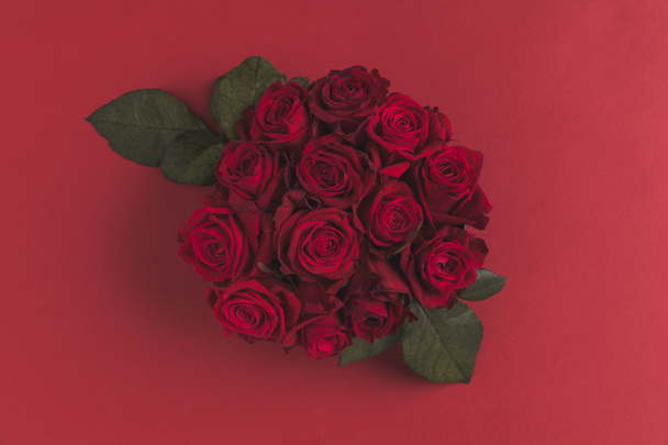 top view of bouquet of red roses isolated on red - Photo, Image