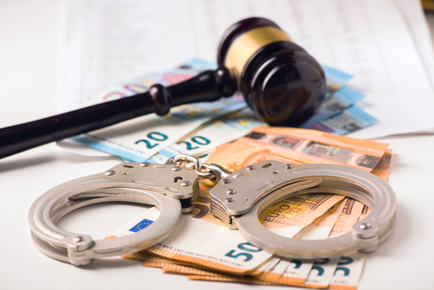 Gavel, handcuff with euro money. Crime and fraud concept - Photo, Image