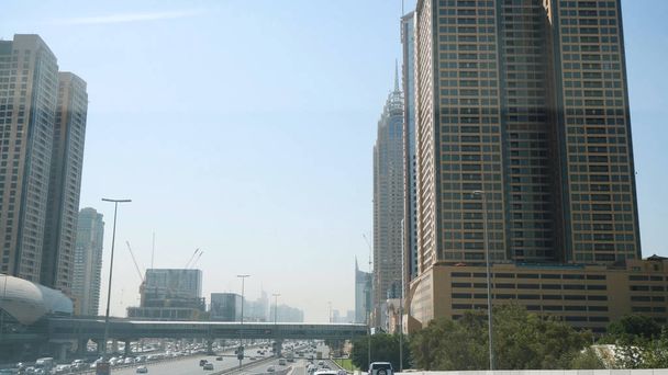 United Arab Emirates, Dubai - October 2017: Beautiful modern architecture Dubai, travel concept. View of the city from the car. View from the interior of the car on the streets of Dubai - Foto, Bild