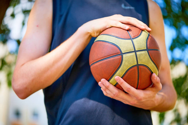 man holding basketball ball, close-up  - Zdjęcie, obraz