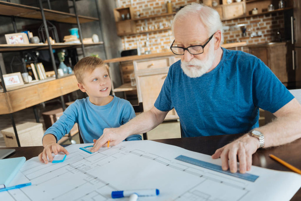 Professional aged engineer working with his grandson - Zdjęcie, obraz