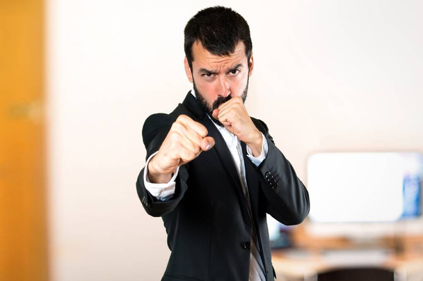 Handsome businessman fighting in the office - Photo, Image