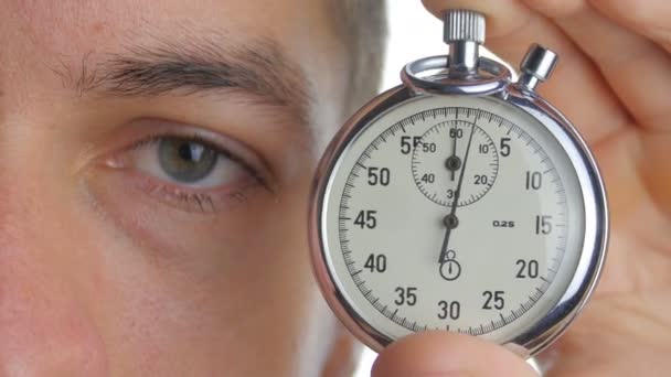 Close up man starting up a stopwatch at white isolated background - Footage, Video