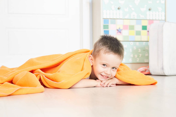 Portrait of a cute baby in orange plaid in home - Foto, Bild