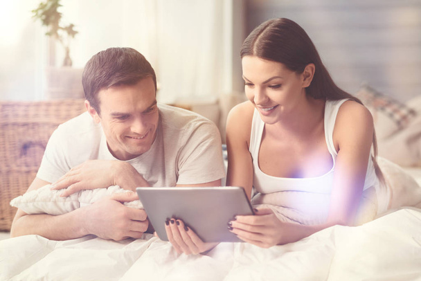 Bright adorable couple watching movie together - Photo, Image