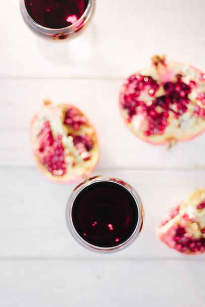 Organic pomegranate wine on white wooden table. - Foto, Bild