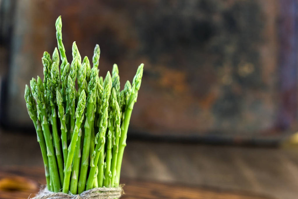 Hip of asparagus standing on wooden board. - Foto, immagini
