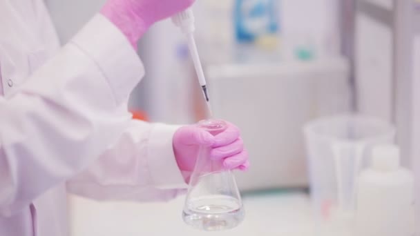 Un biotechnologue prélève un échantillon de liquide à analyser. Gros plan
. - Séquence, vidéo
