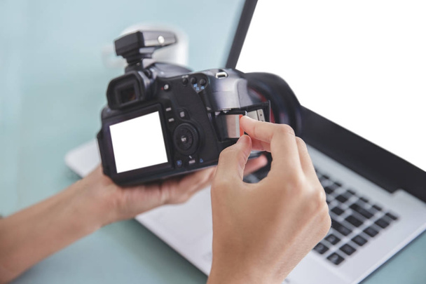 hand of photographer inserting the memory card to the camera - Φωτογραφία, εικόνα