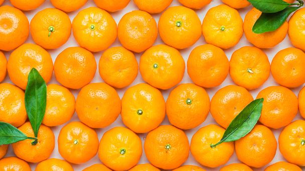 Christmas  tangerine mood!) Wreath made of  fresh small tangerines and green leaves on white wooden background. The best xmas celebration background.  Flat lay, top view, copy space.  - Photo, Image