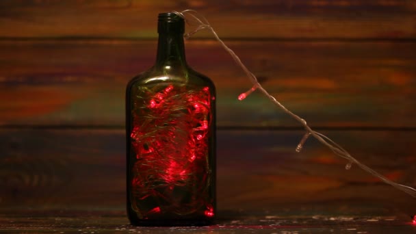 Decorations for the New Year. Garland with flashing lights inside the bottle. Creative solutions. Christmas decorations - Footage, Video