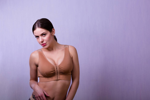 Woman wearing a compressing bra - Zdjęcie, obraz